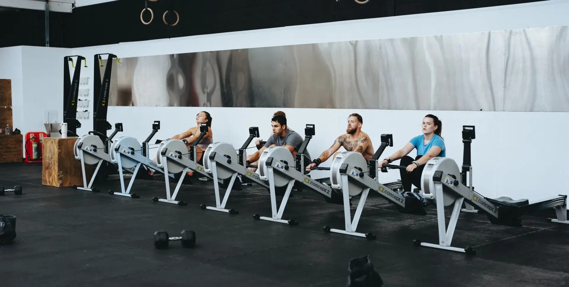 Group working our on rowers